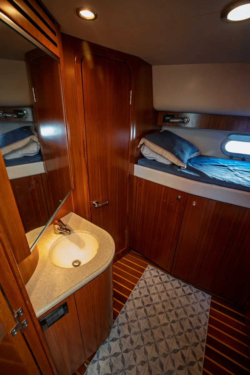 Slide: The Image of The 2006 Tiara Yachts 4400 Sovran cabin features elegant wood interior and a sink. - 31