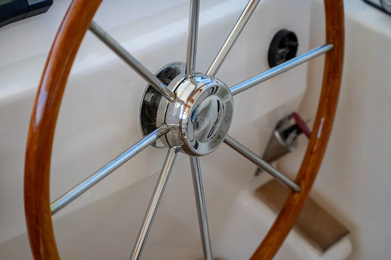 Slide: The Image of Close-up of a shiny wood and metal steering wheel on a 2006 Tiara Yachts 4400 Sovran. - 13
