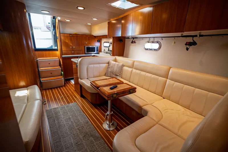 Slide: The Image of Interior of the 2006 Tiara Yachts 4400 Sovran with elegant wood furnishings and comfortable white sofas. - 44