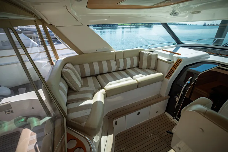Slide: The Image of Interior of a 2006 Tiara Yachts 4400 Sovran with elegant seating area and large windows. - 23