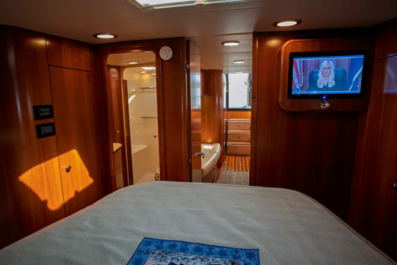 Slide: The Image of The cabin of a 2006 Tiara Yachts 4400 Sovran with wood paneling and a television. - 42