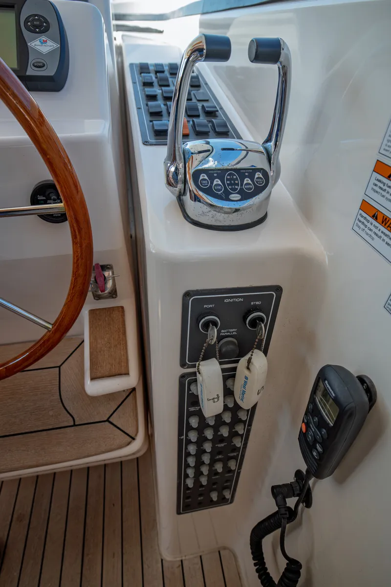 Slide: The Image of Close-up of the helm station on a 2006 Tiara Yachts 4400 Sovran with throttle and switches. - 21