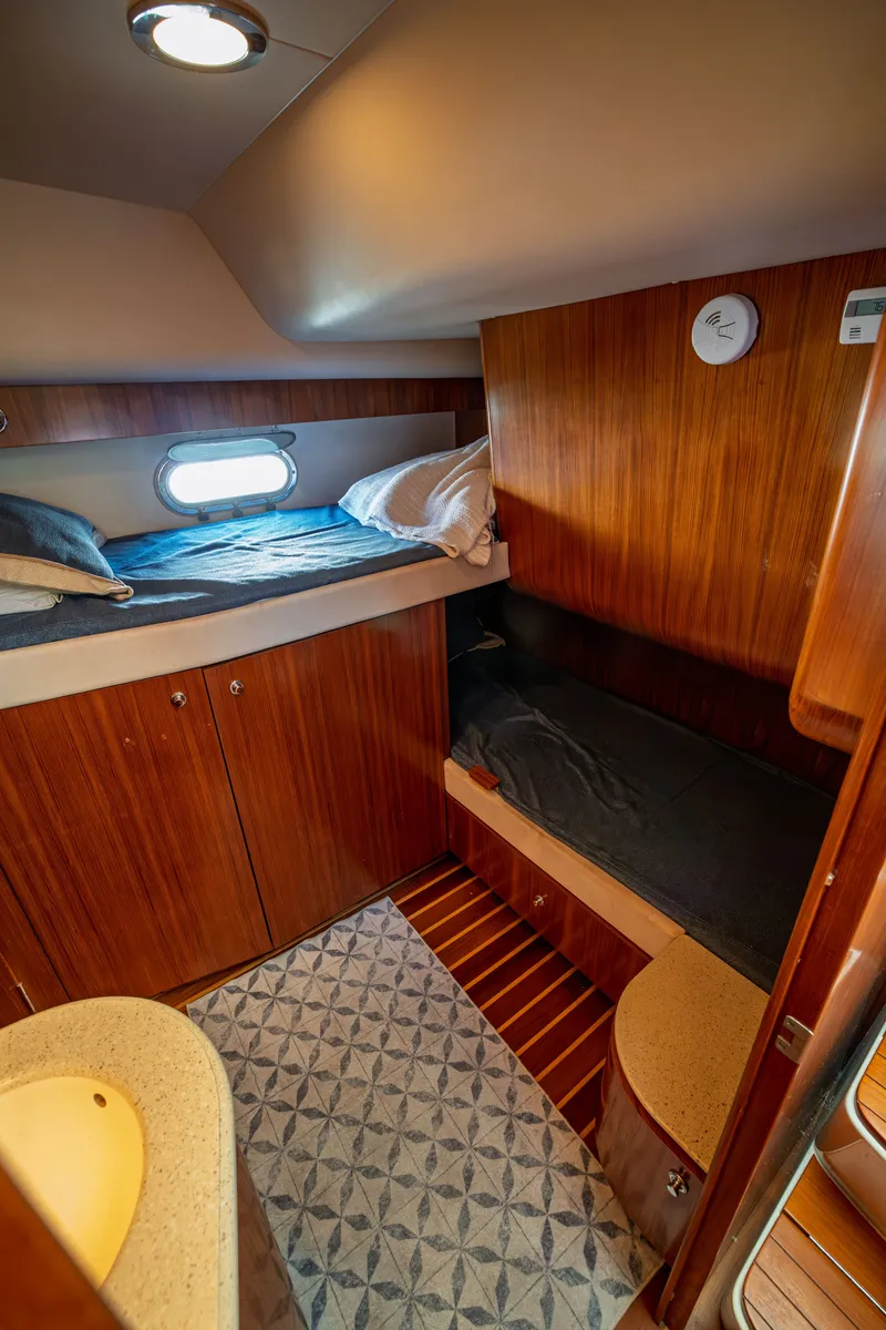 Slide: The Image of The cabin of a 2006 Tiara Yachts 4400 Sovran with two beds and wooden furnishings. - 30