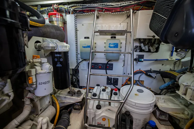 Slide: The Image of The engine room of a 2006 Tiara Yachts 4400 Sovran shows engines, piping, and maintenance equipment. - 48