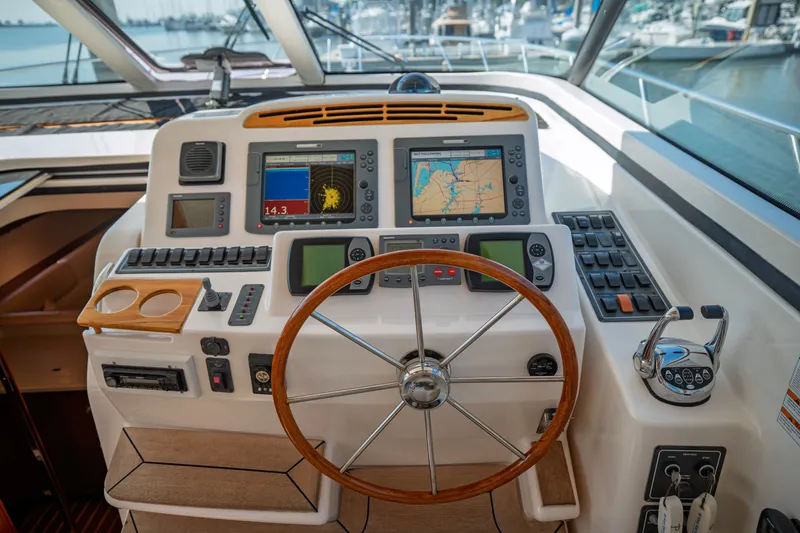 Slide: The Image of The image shows the helm of a 2006 Tiara Yachts 4400 Sovran with modern navigation systems. - 15