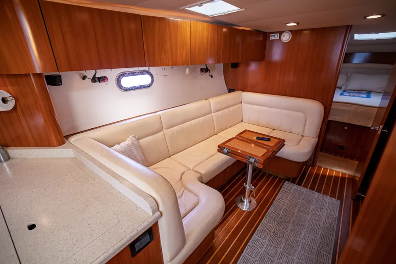 Slide: The Image of Interior of the 2006 Tiara Yachts 4400 Sovran with elegant seating and wood furnishings. - 34