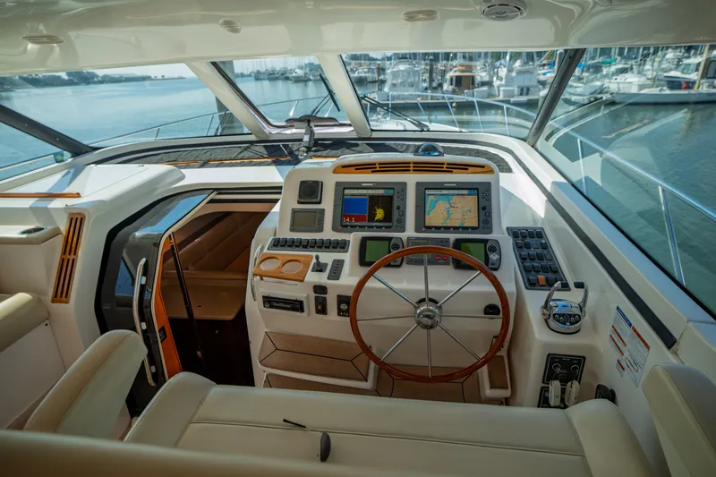 Slide: The Image of The 2006 Tiara Yachts 4400 Sovran cockpit features modern navigation equipment and a sleek design. - 14