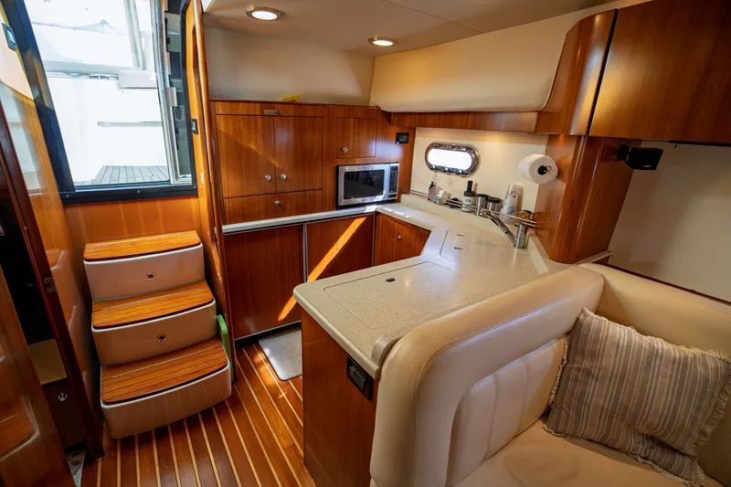 Slide: The Image of Interior of the 2006 Tiara Yachts 4400 Sovran with elegant kitchen and wooden cabinetry. - 33