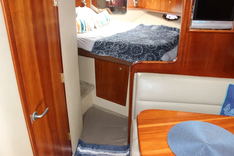 Slide: The Image of Interior of 2007 Cruisers Yachts 340 Express with cozy bed and dining area. - 34