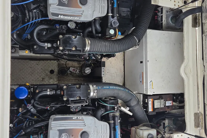 Slide: The Image of Engine compartment of a 2007 Cruisers Yachts 340 Express, featuring dual Horizon MerCruiser engines. - 53