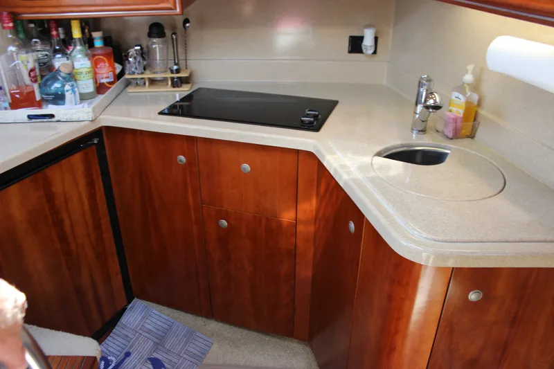 Slide: The Image of Luxurious 2007 Cruisers Yachts 340 Express kitchen with wood cabinetry and modern amenities. - 32