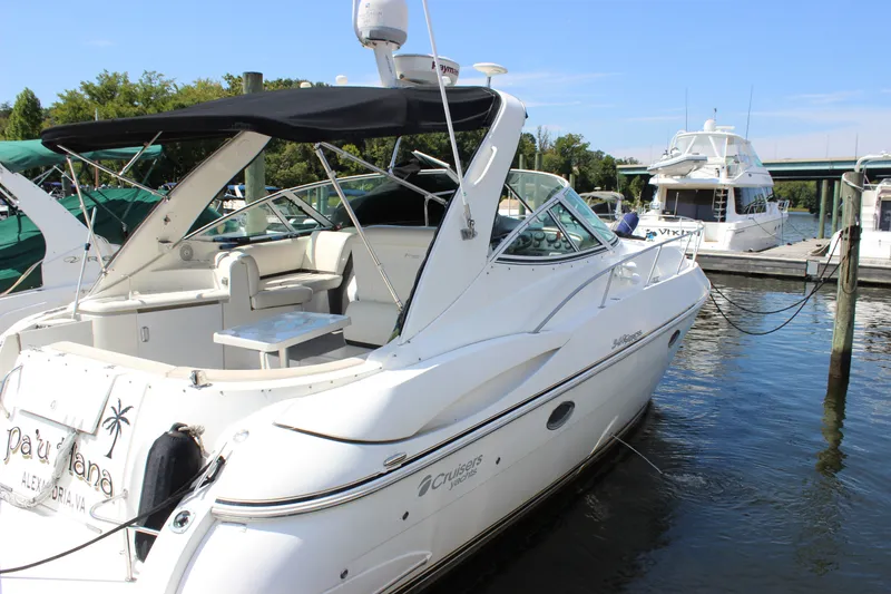 Slide: The Image of 2007 Cruisers Yachts 340 Express docked at marina, featuring sleek design and spacious deck. - 5
