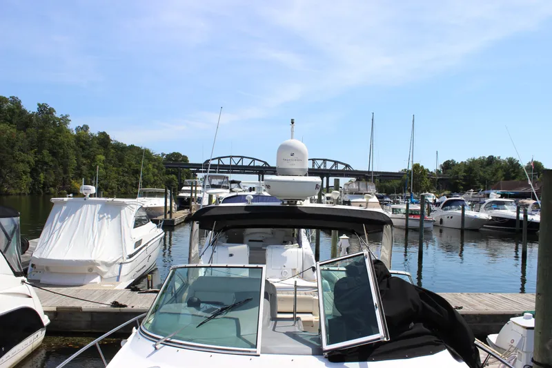 Slide: The Image of 2007 Cruisers Yachts 340 Express docked at a marina with other boats. - 27