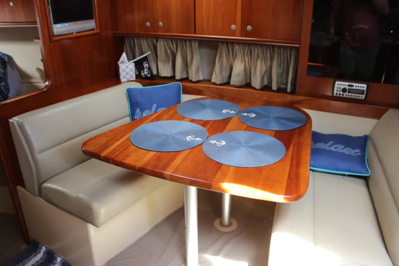 Slide: The Image of Interior of 2007 Cruisers Yachts 340 Express with dining area and wooden table. - 36