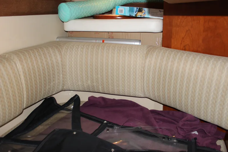 Slide: The Image of Interior seating area of 2007 Cruisers Yachts 340 Express with cushions and storage items. - 49