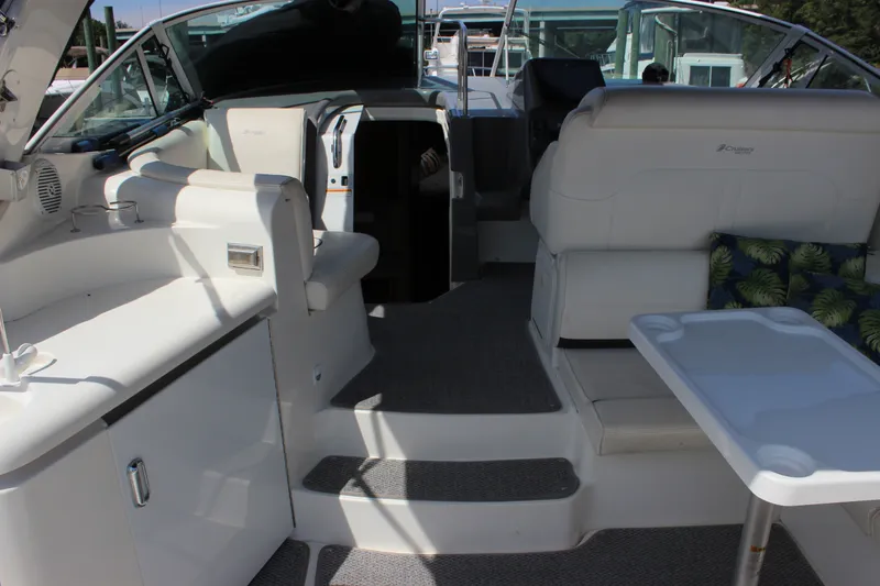 Slide: The Image of 2007 Cruisers Yachts 340 Express interior with white seating and table, showcasing luxury design. - 9
