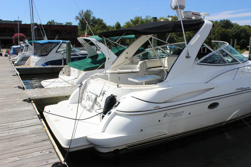 Slide: The Image of 2007 Cruisers Yachts 340 Express docked at marina, featuring sleek white design. - 7