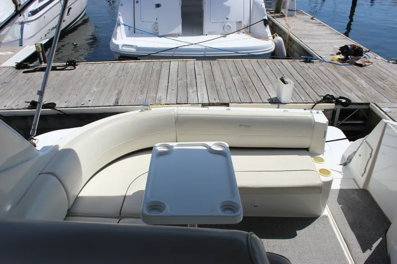 Slide: The Image of 2007 Cruisers Yachts 340 Express interior with seating and table, docked at marina. - 15