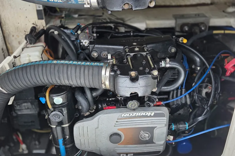 Slide: The Image of Engine compartment of a 2007 Cruisers Yachts 340 Express, featuring a Horizon 6.2 engine. - 54