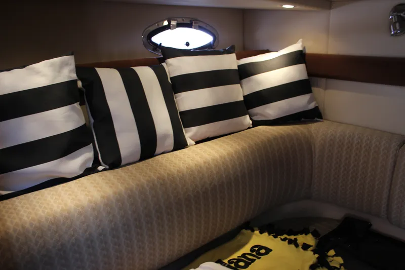 Slide: The Image of Interior of 2007 Cruisers Yachts 340 Express with striped cushions and cozy seating. - 50