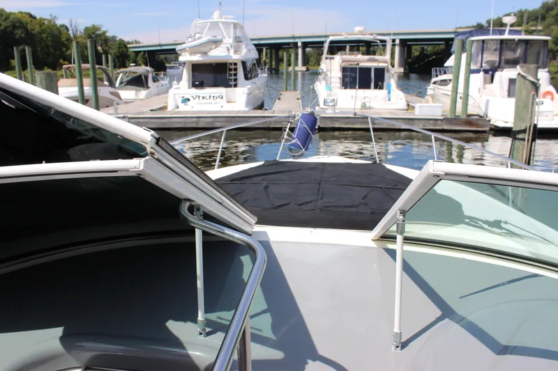 Slide: The Image of 2007 Cruisers Yachts 340 Express docked at marina, view from bow. - 14