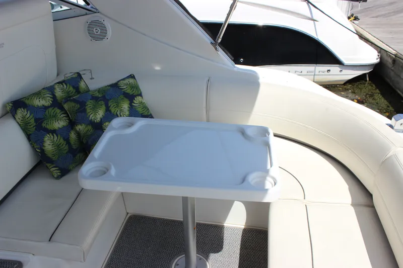 Slide: The Image of Luxurious 2007 Cruisers Yachts 340 Express interior with cushioned seating and tropical pillows. - 11