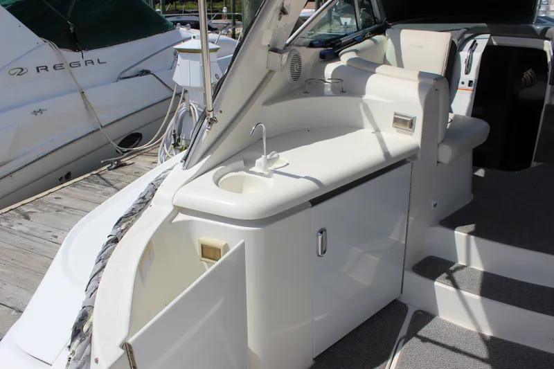 Slide: The Image of 2007 Cruisers Yachts 340 Express boat interior with sink and seating area. - 8