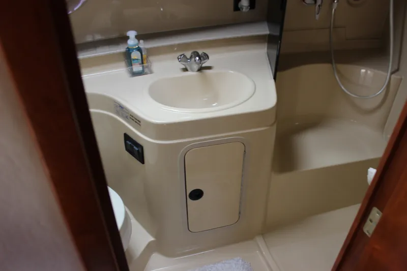 Slide: The Image of 2007 Cruisers Yachts 340 Express bathroom with sink, shower, and toiletries. - 42