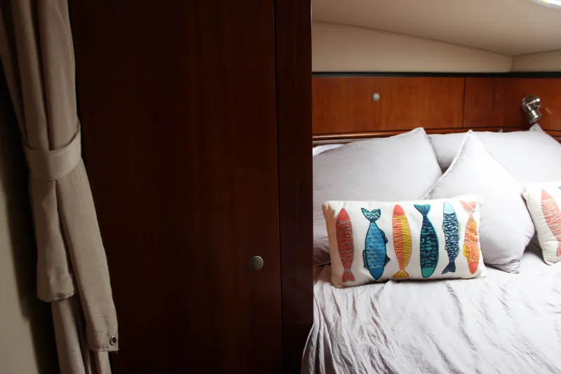 Slide: The Image of Cozy cabin interior of 2007 Cruisers Yachts 340 Express with colorful fish-themed pillows. - 44
