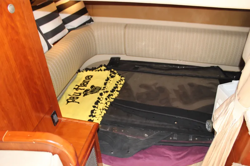 Slide: The Image of Cozy interior of 2007 Cruisers Yachts 340 Express with striped pillows and decorative blanket. - 38