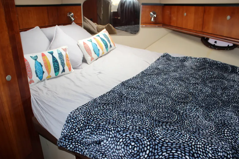 Slide: The Image of Luxurious cabin interior of 2007 Cruisers Yachts 340 Express with cozy bedding and decorative pillows. - 43