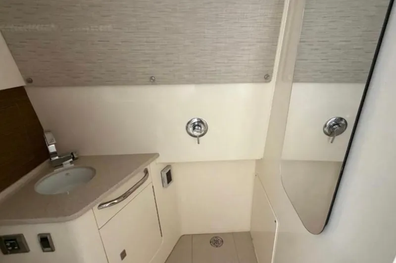 Slide: The Image of 2017 Boston Whaler 420 Outrage bathroom with sink, mirror, and modern fixtures. - 58