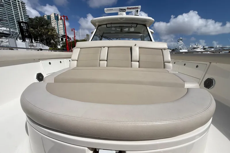 Slide: The Image of 2017 Boston Whaler 420 Outrage boat with spacious seating, docked under a clear blue sky. - 37