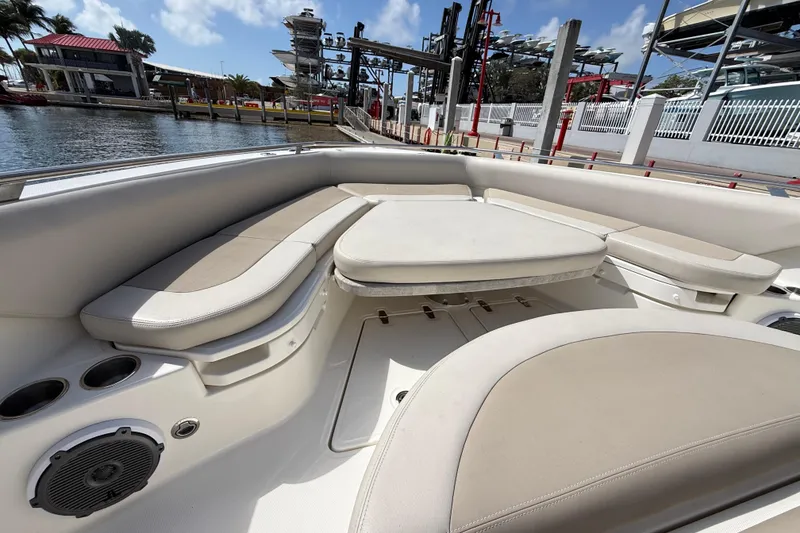Slide: The Image of 2017 Boston Whaler 420 Outrage boat interior with cushioned seating and cup holders. - 38