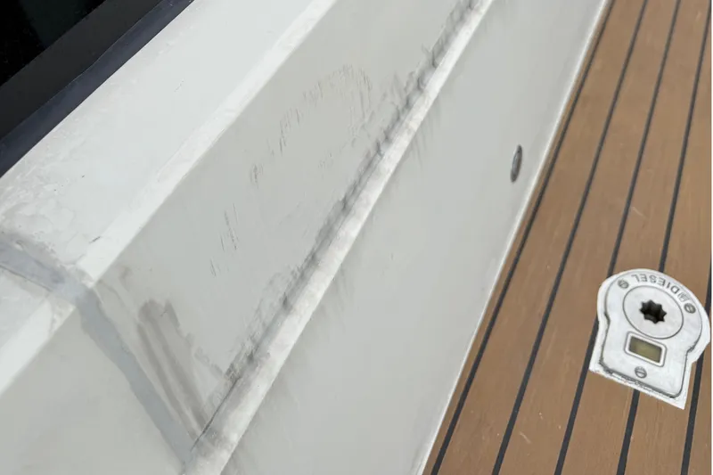 Slide: The Image of Close-up of 2012 Fairline Targa 58 yacht deck with diesel cap and visible wear. - 87