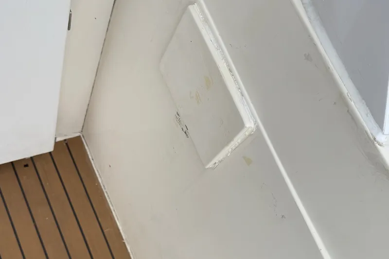 Slide: The Image of Interior detail of a 2012 Fairline Targa 58 yacht, featuring a white panel and wooden flooring. - 98