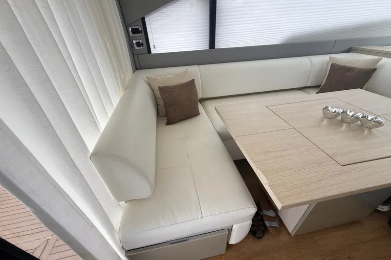 Slide: The Image of Luxurious interior of 2012 Fairline Targa 58 yacht with white leather seating and wooden table. - 74