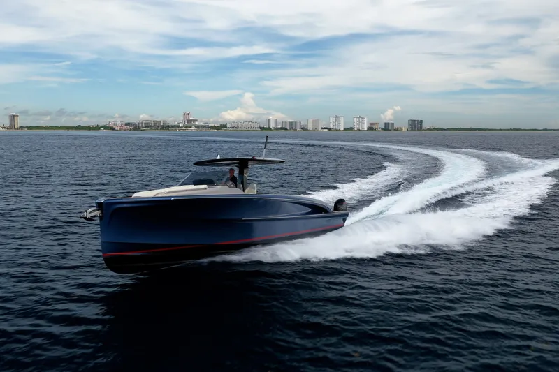 Slide: The Image of 2024 Solaris Power 40F Open yacht cruising on open water near city skyline. - 51