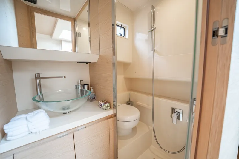 Slide: The Image of Luxurious bathroom in 2024 Solaris Power 40F Open yacht with modern fixtures and glass sink. - 28