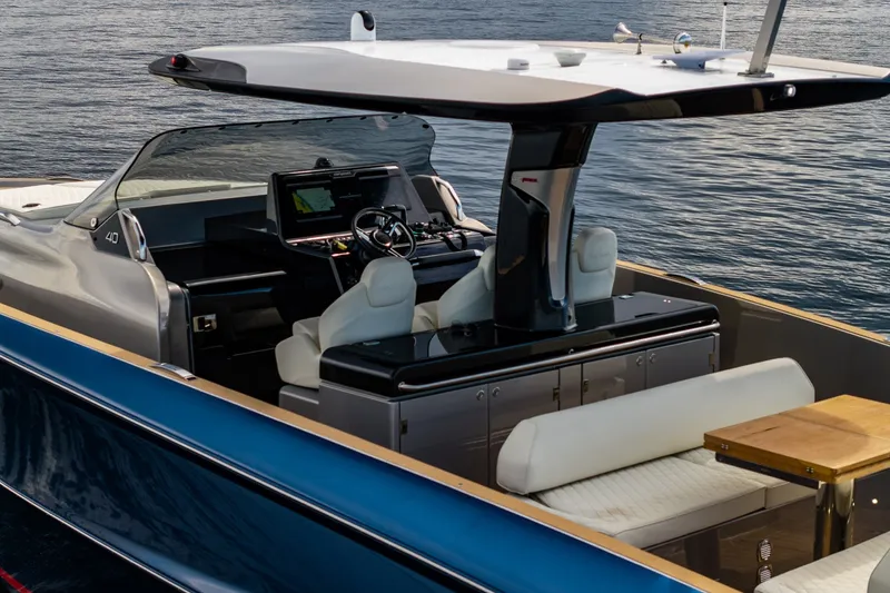 Slide: The Image of 2024 Solaris Power 40F Open yacht interior with helm, seating, and table on calm water. - 17
