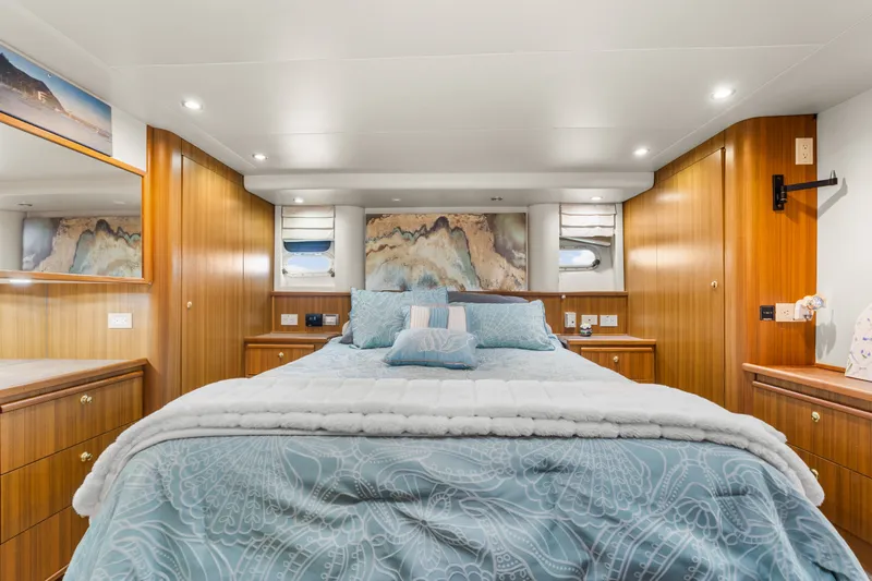 Slide: The Image of Luxurious bedroom interior of 2001 Bayliner 5788 Pilot House Motoryacht with elegant wood paneling. - 31