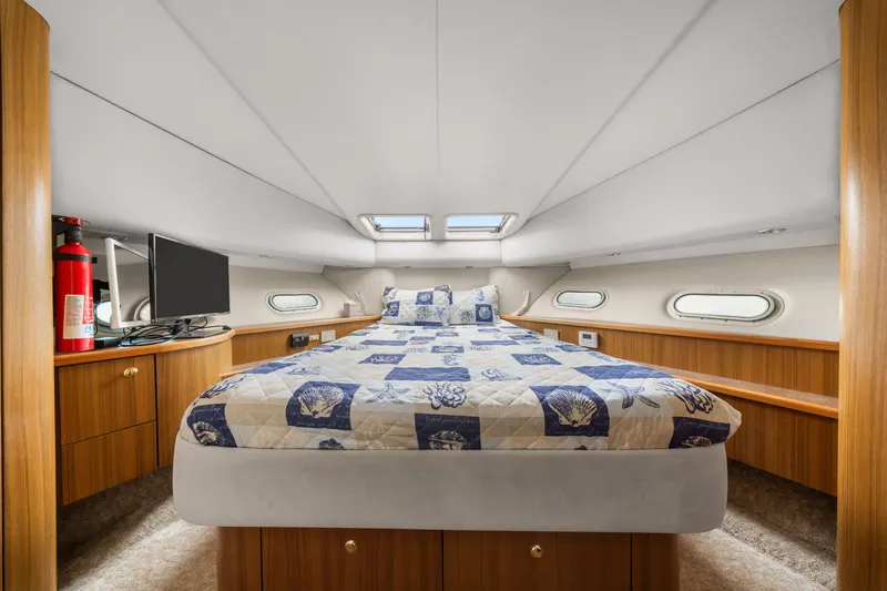 Slide: The Image of Luxurious bedroom interior of 2001 Bayliner 5788 Pilot House Motoryacht with nautical-themed bedding. - 36