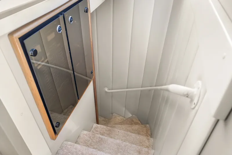 Slide: The Image of Staircase inside 2001 Bayliner 5788 Pilot House Motoryacht with carpeted steps and handrail. - 27