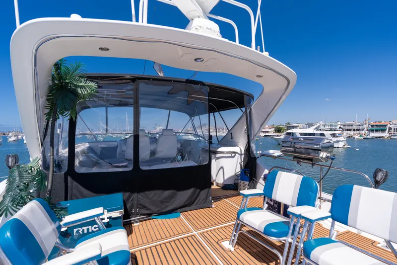 Slide: The Image of 2001 Bayliner 5788 Pilot House Motoryacht with seating area and marina view. - 14