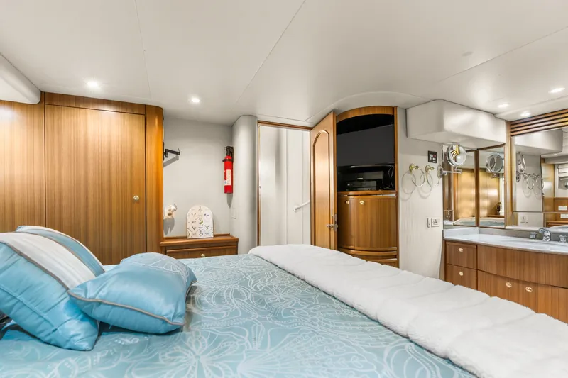 Slide: The Image of Luxurious bedroom interior of 2001 Bayliner 5788 Pilot House Motoryacht with elegant wood finishes. - 32