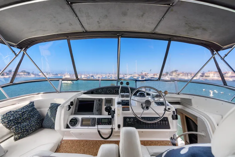 Slide: The Image of 2001 Bayliner 5788 Pilot House Motoryacht helm with panoramic marina view. - 42