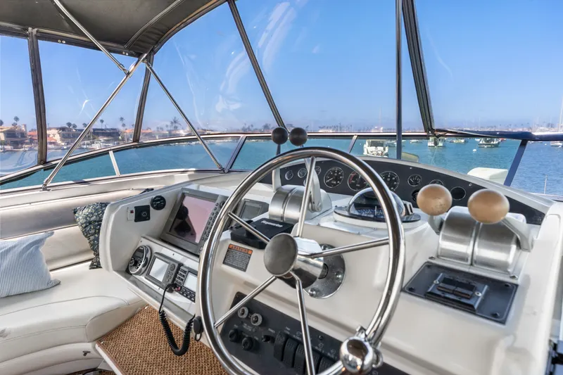 Slide: The Image of 2001 Bayliner 5788 Pilot House Motoryacht helm with ocean view and navigation equipment. - 43