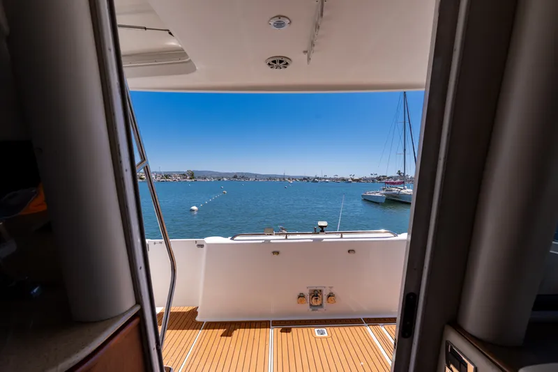 Slide: The Image of View from 2001 Bayliner 5788 Pilot House Motoryacht, overlooking serene marina waters. - 13