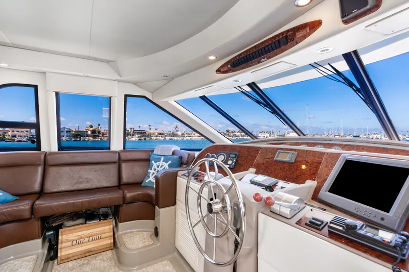 Slide: The Image of Luxurious 2001 Bayliner 5788 Pilot House Motoryacht interior with helm and panoramic windows. - 24