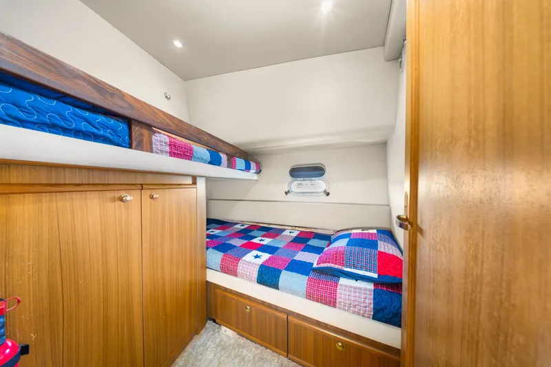 Slide: The Image of Cozy cabin interior of 2001 Bayliner 5788 Pilot House Motoryacht with colorful bedding. - 38